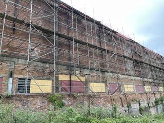 Scaffolded brick building during repair works